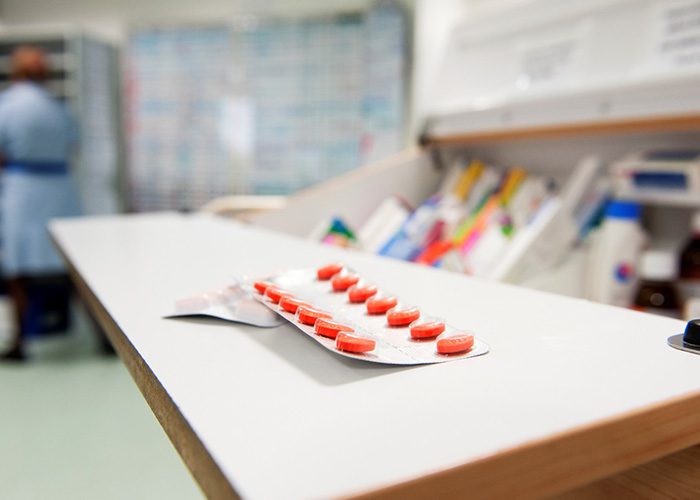 Orange tablets in packaging on a worktop