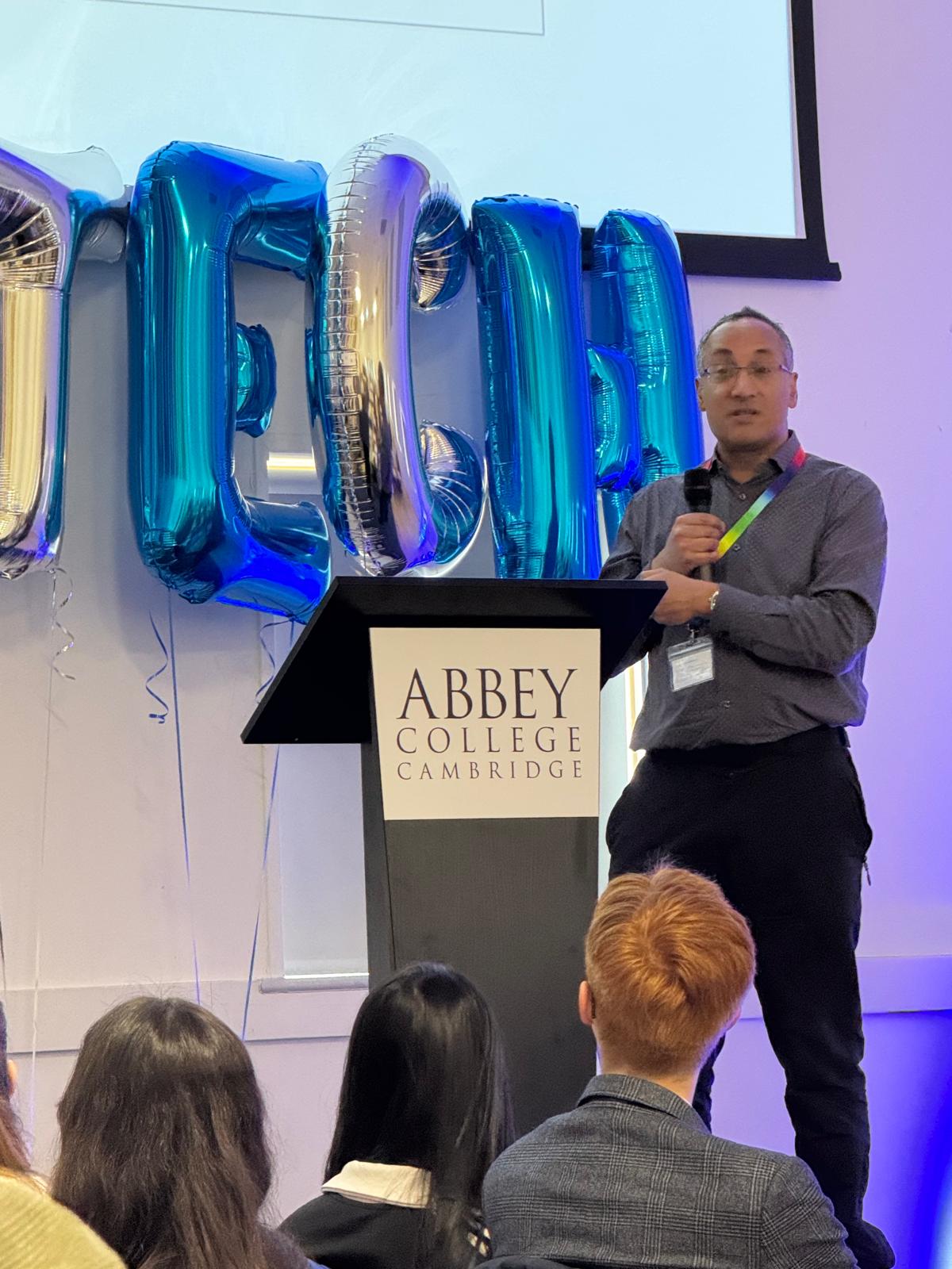 Man standing on a stage talking