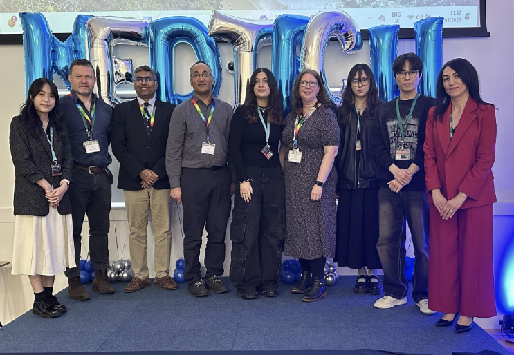 A line up of 9 different people standing on a stage