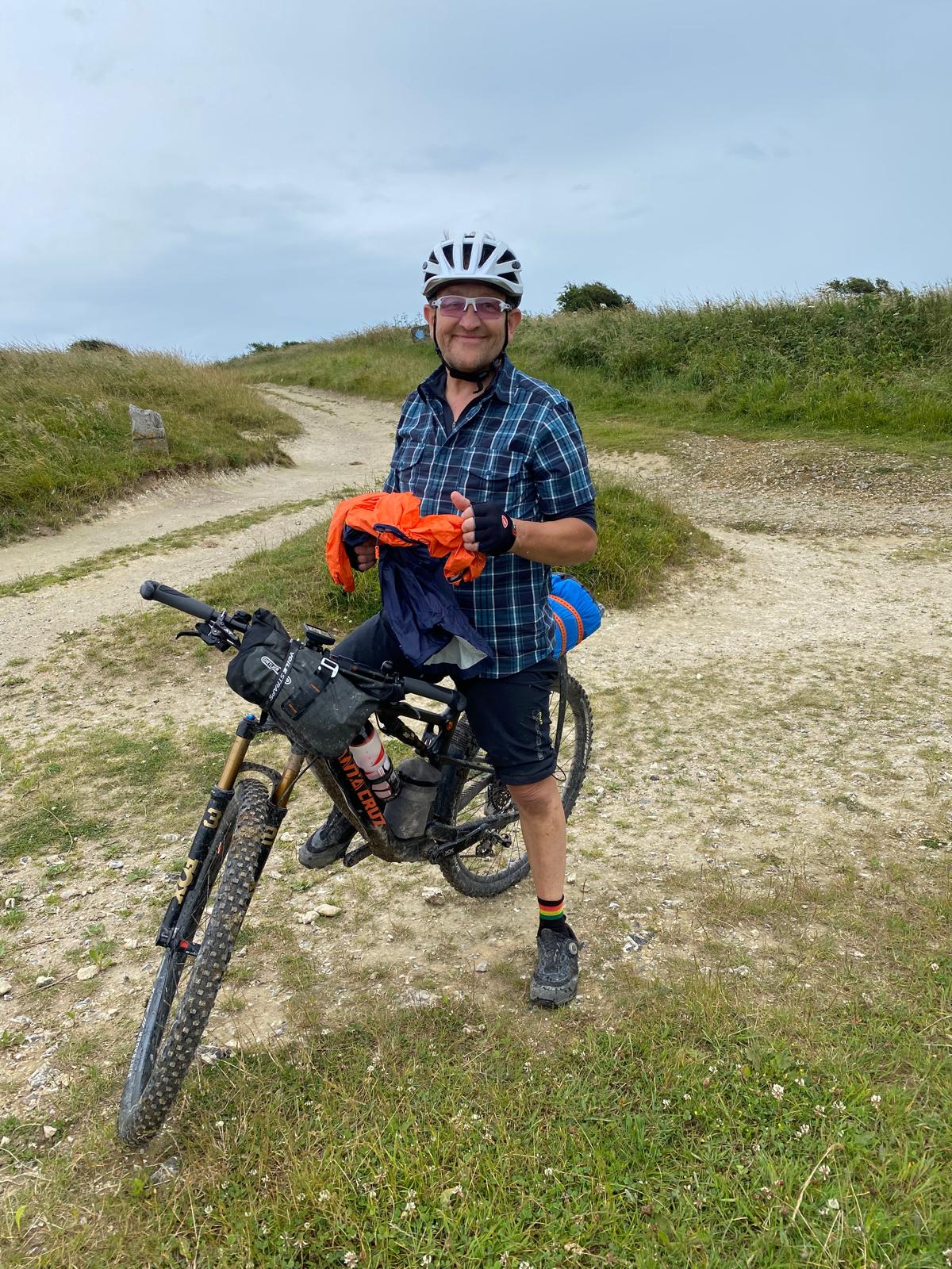 Man on a bicycle by sand dunes