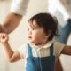 Young baby walking looking to the side