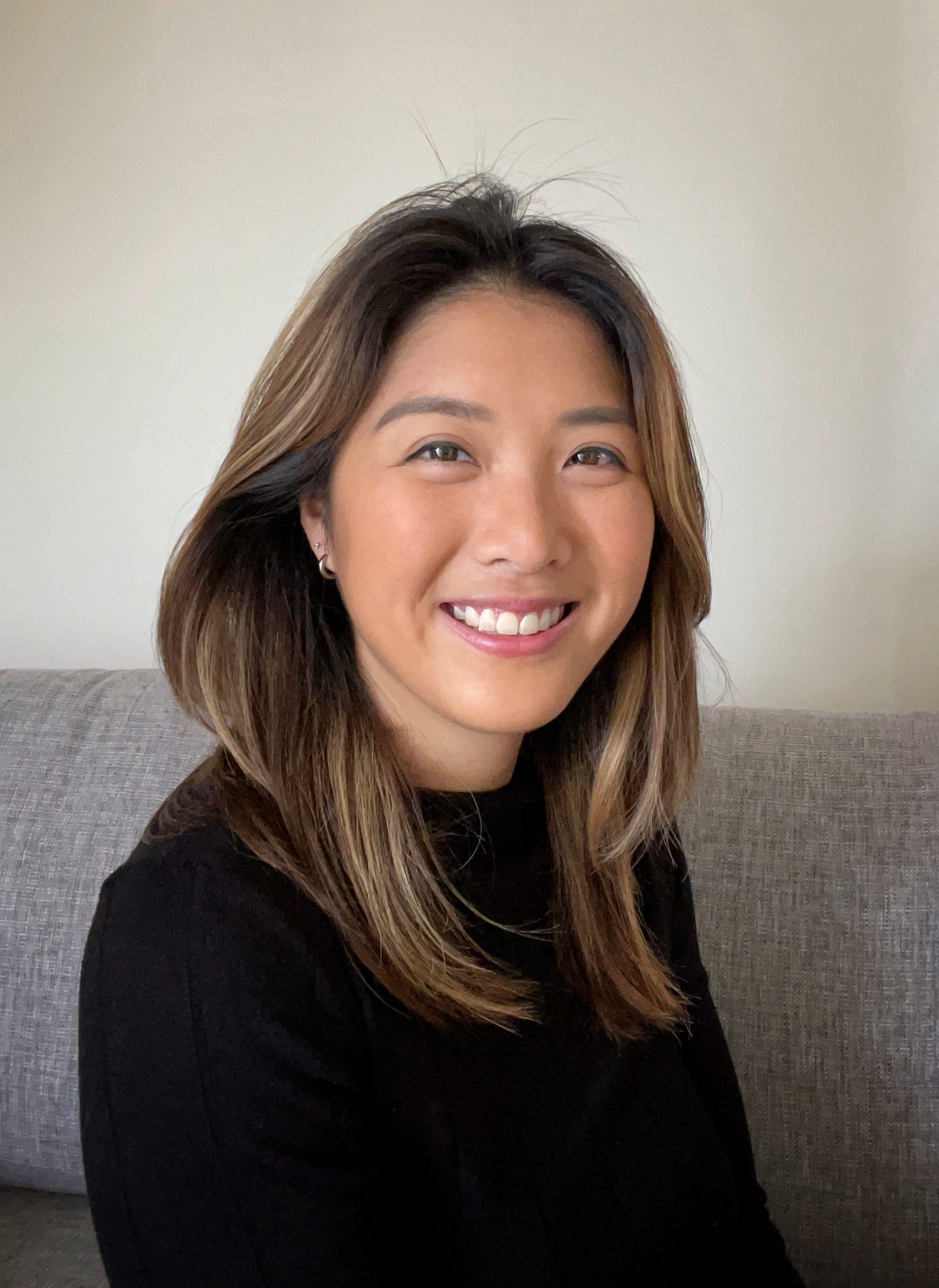 Woman in a black top looking at the camera smiling