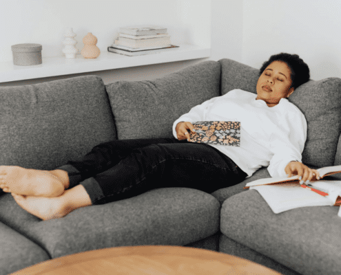 Woman asleep on the sofa. Credit: Canva