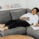 Woman asleep on the sofa. Credit: Canva