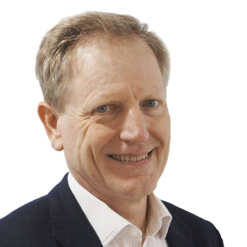 Man in a suit smiling at the camera